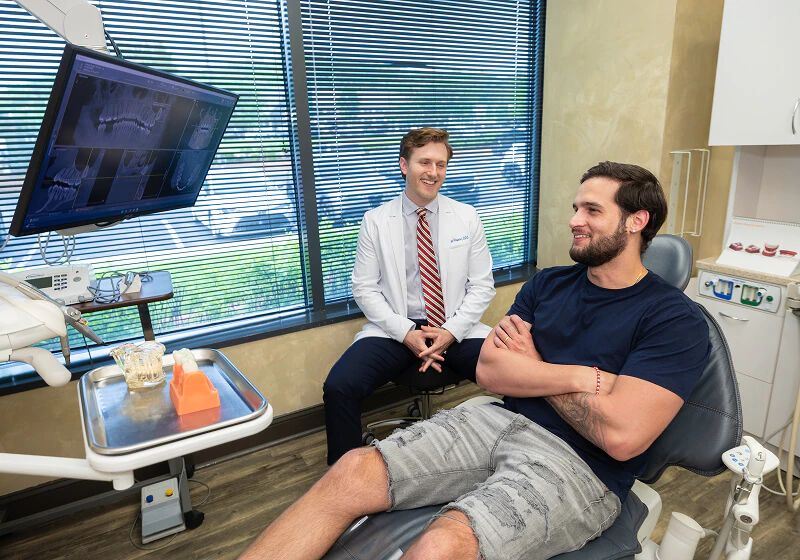 patient smiling during his emergency visit to Brentwood Dental Excellence