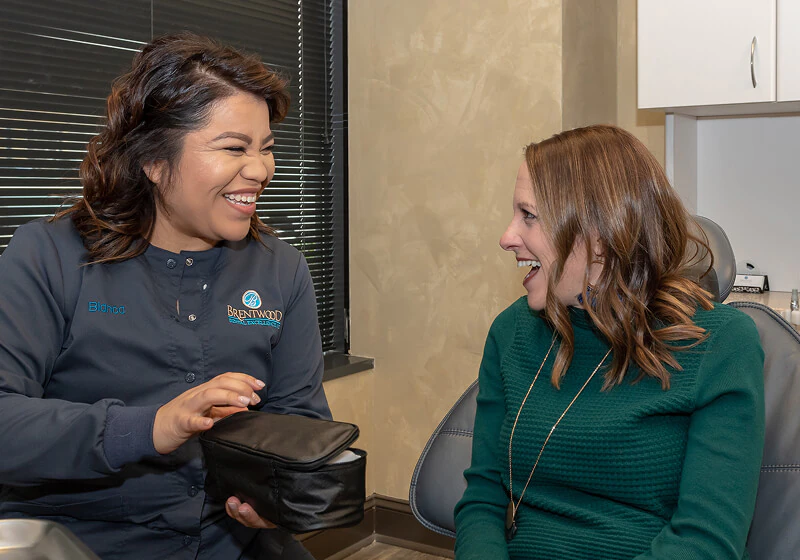 patient smiling during her teeth whitening appointment at Brentwood Dental Excellence